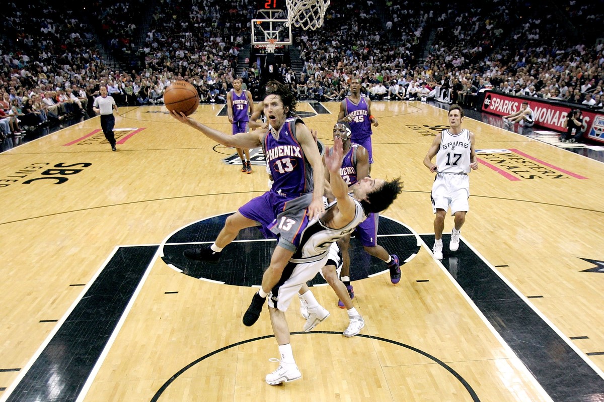 Steve Nash #13 of the Phoenix Suns goes to the basket over Manu Ginobili #20 of the San Antonio Spurs